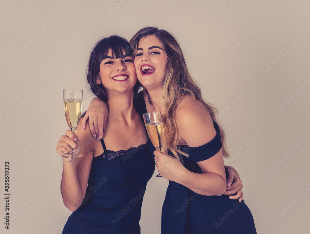 Portrait of two young attractive women with champagne glasses at celebration party Portrait of two young attractive women with champagne glasses at celebration party