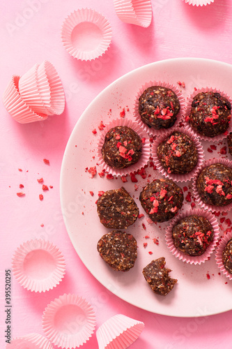 Sugar free, raw, vegan, energy protein balls made with dates, almonds, coconut oil, cocoa nibs and freeze dried strawberries photo