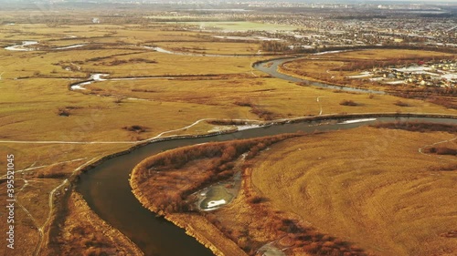 Aerial View Of Forest Woods And Partly Frozen River Landscape In Sunny Late Autunn Day. Top View Of Beautiful European Nature From High Attitude In Autumn Season. Drone View. Bird's Eye View photo