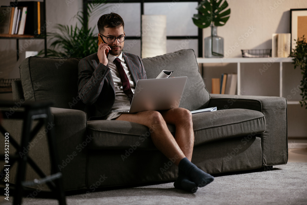 Businessman with no pants working at home. Young man using the laptop having video call. Businessman with no pants working at home. Young man using the laptop having video call.