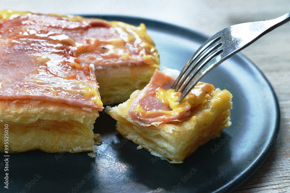 grilled toast topping ham pork and cheese stabbing by fork on plate grilled toast topping ham pork and cheese stabbing by fork on plate