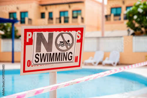 Abandoned swimming pool at the time of epidemic. Health measures. No swimming sign.Pool under closure. Consequences of self isolation during coronavirus times. Restrictions for any group activities.