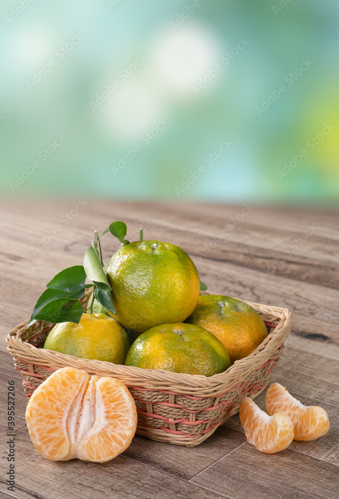 Fresh ripe tangerine mandarin orange on wooden table background.