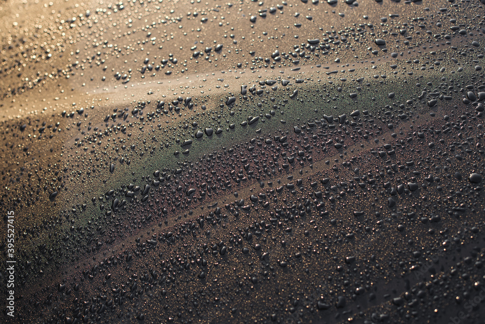 water drops on dark metal background water drops on dark metal background