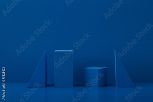 Monochromatic composition with blue geometric figures on a blue background