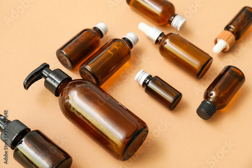 Cosmetic bottles on color background