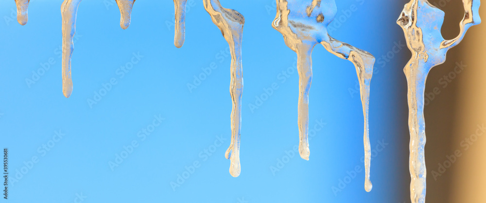 Fototapeta premium Icicles in winter against a blue sky.
