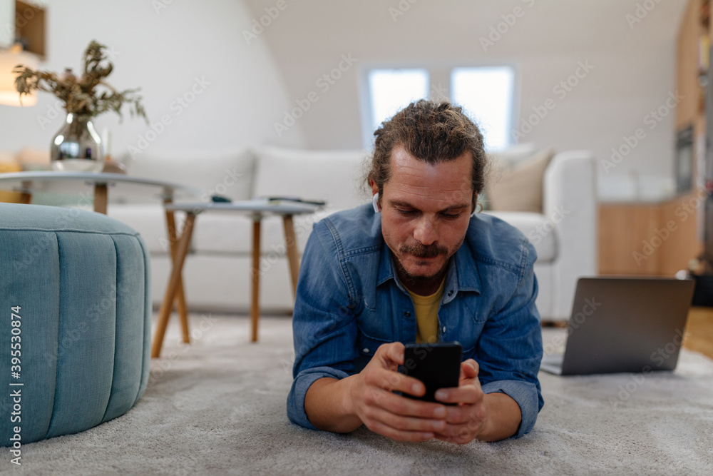 Man using wireless technology at home Man using wireless technology at home