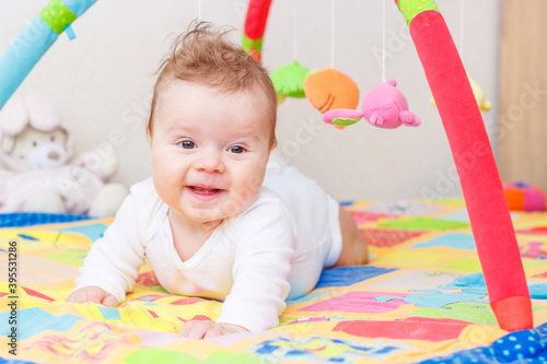 Playing child on the colored mat for developing, soft focus background