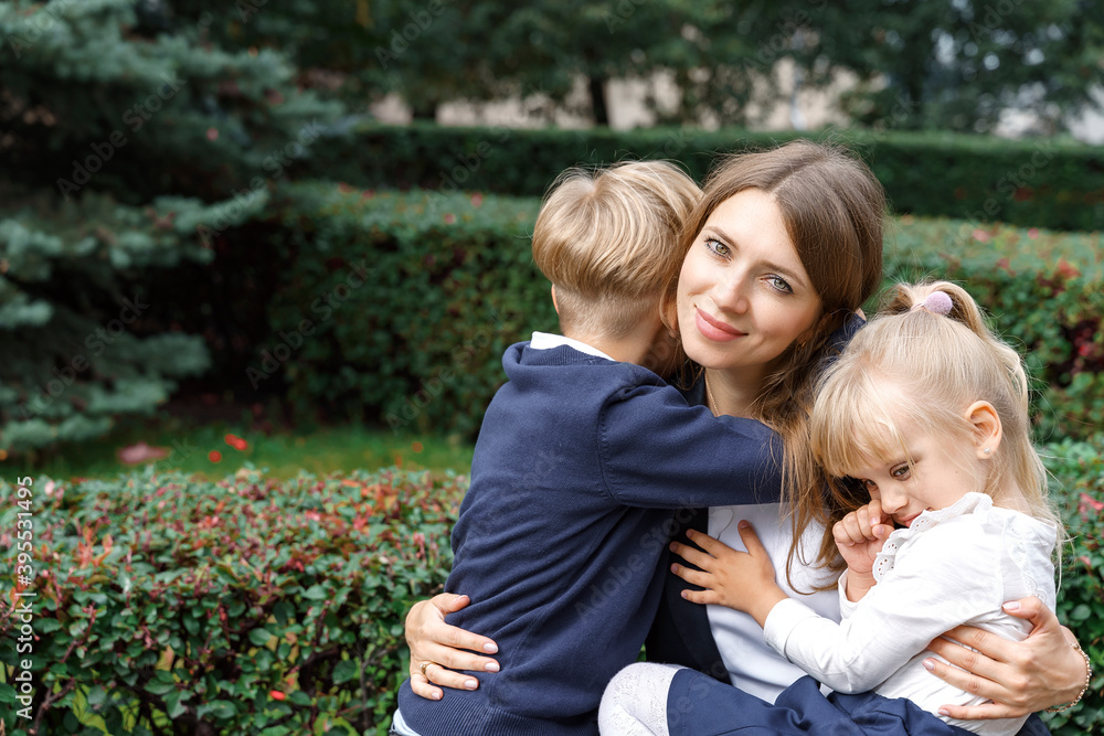 Fototapeta premium portrait of mother and two children on a walk on a summer day