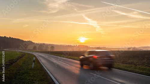 car driving on the road at sunset