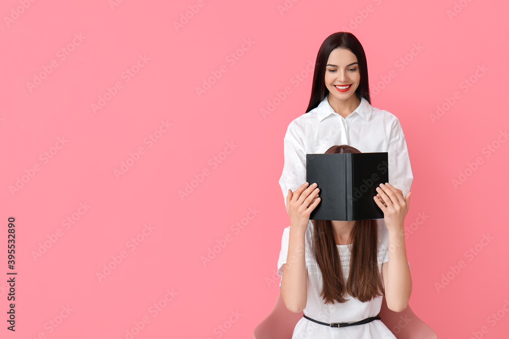 Young women with book on color background Young women with book on color background