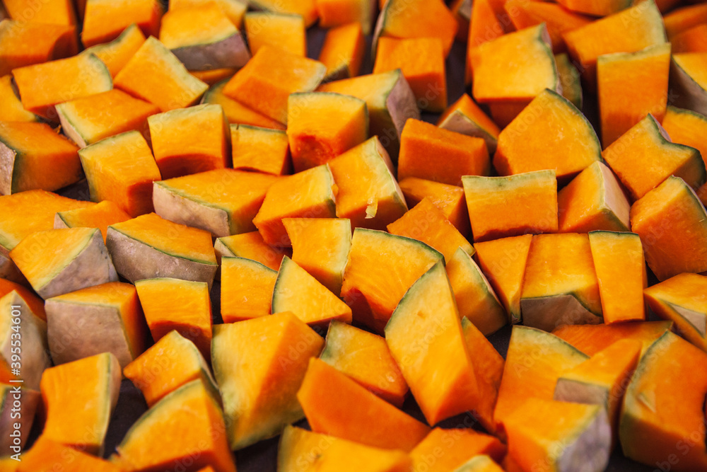 The choped raw pumpkin texture, closeup. Flat lay of freshly cut vegetables. Concept of healthy lifestyle, vegan diet The choped raw pumpkin texture, closeup. Flat lay of freshly cut vegetables. Concept of healthy lifestyle, vegan diet