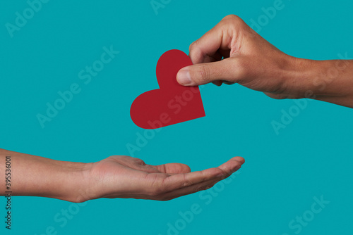 person giving a heart to another person photo