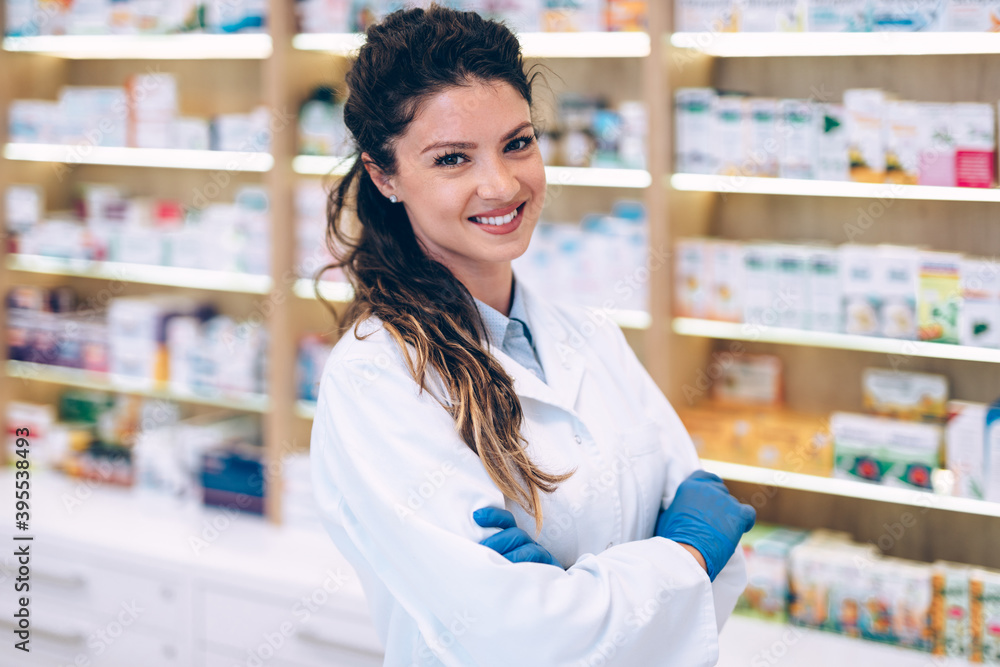 Portrait of a smiling healthcare worker in modern pharmacy.