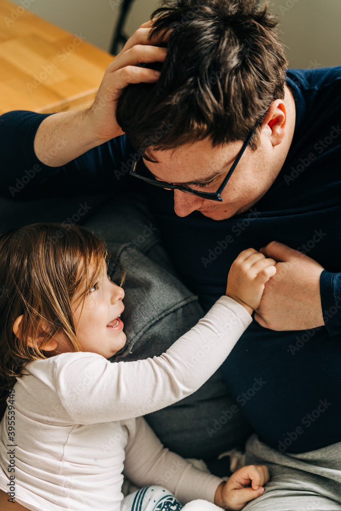 Father with child on the couch. Cozy home activity with child. fatherhood Father with child on the couch. Cozy home activity with child. fatherhood