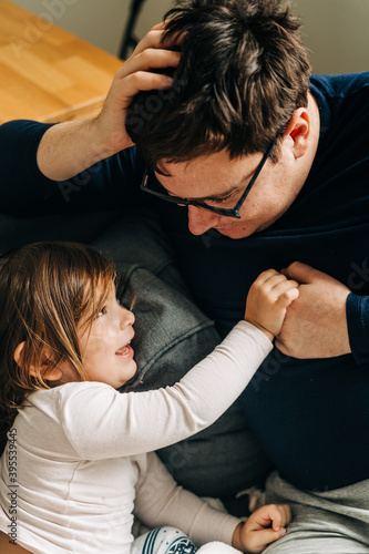 Father with child on the couch. Cozy home activity with child. fatherhood