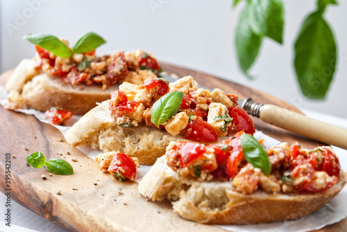 Bruschetta with cherry tomatoes and sheep�s cheese photo