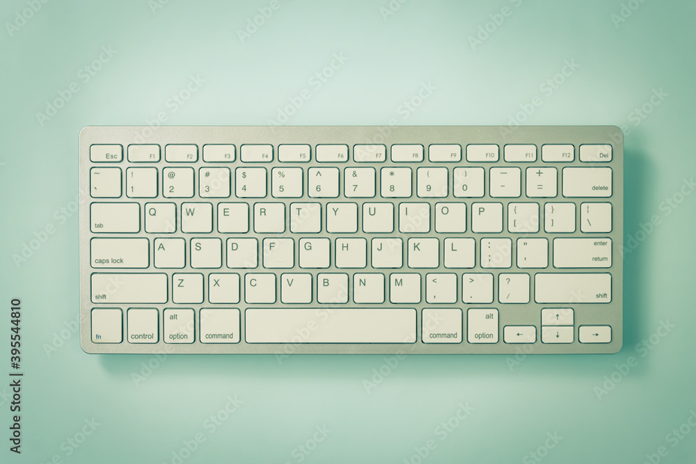 White Portable Computer Keyboard Keys or Keyboard Button on Blue Pastel Minimalist Background at Center Frame in Vintage Tone White Portable Computer Keyboard Keys or Keyboard Button on Blue Pastel Minimalist Background at Center Frame in Vintage Tone