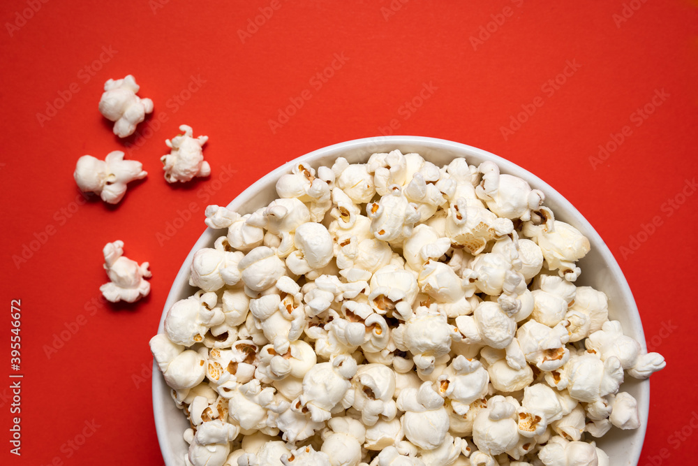 bowl of popcorn on a red background. view from above bowl of popcorn on a red background. view from above