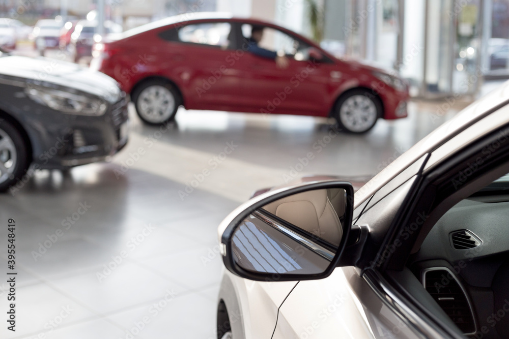 New cars at dealer showroom. Themed blur background with bokeh effect. Car auto dealership. New cars at dealer showroom. Themed blur background with bokeh effect. Car auto dealership.