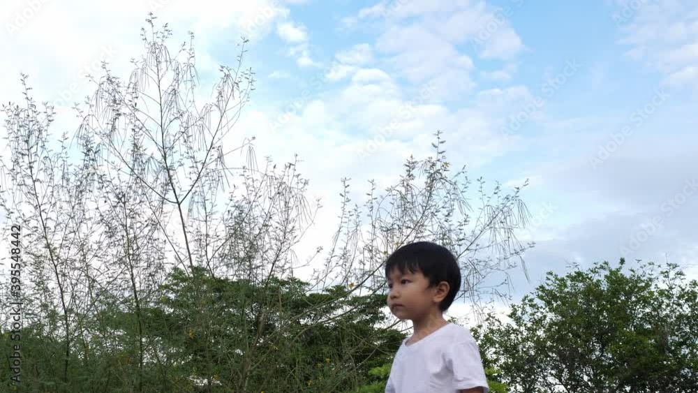 4K Asian cute child boy playing spin fly to sky in nature blue background in rural place. Concept of fun family activity, success concept, slow motion shot 4K Asian cute child boy playing spin fly to sky in nature blue background in rural place. Concept of fun family activity, success concept, slow motion shot
