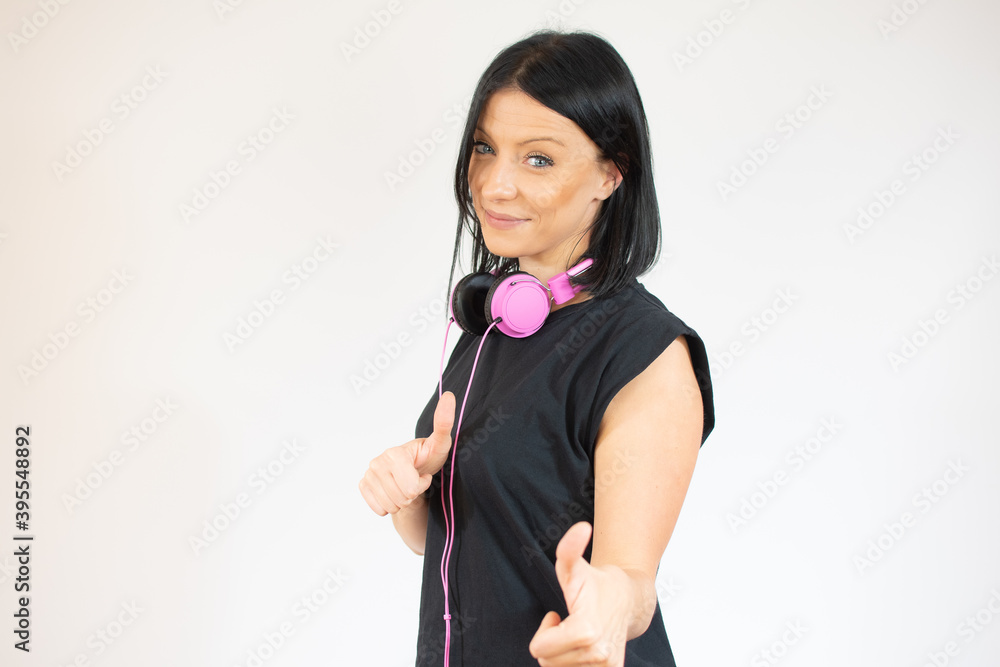 Young brunette woman with blue eyes wearing casual black t-shirt over isolated white background approving doing positive gesture with hand, thumb up smiling and happy for success. Winner gesture. Young brunette woman with blue eyes wearing casual black t-shirt over isolated white background approving doing positive gesture with hand, thumb up smiling and happy for success. Winner gesture.