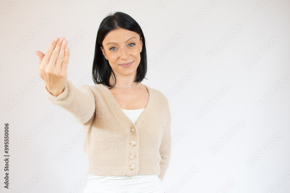 Young pretty woman inviting to come, confident and smiling making a gesture with hand, being positive and friendly Young pretty woman inviting to come, confident and smiling making a gesture with hand, being positive and friendly