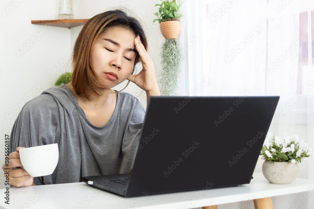 tired and sleepy Asian woman worker drinking coffee overworked from home office tired and sleepy Asian woman worker drinking coffee overworked from home office