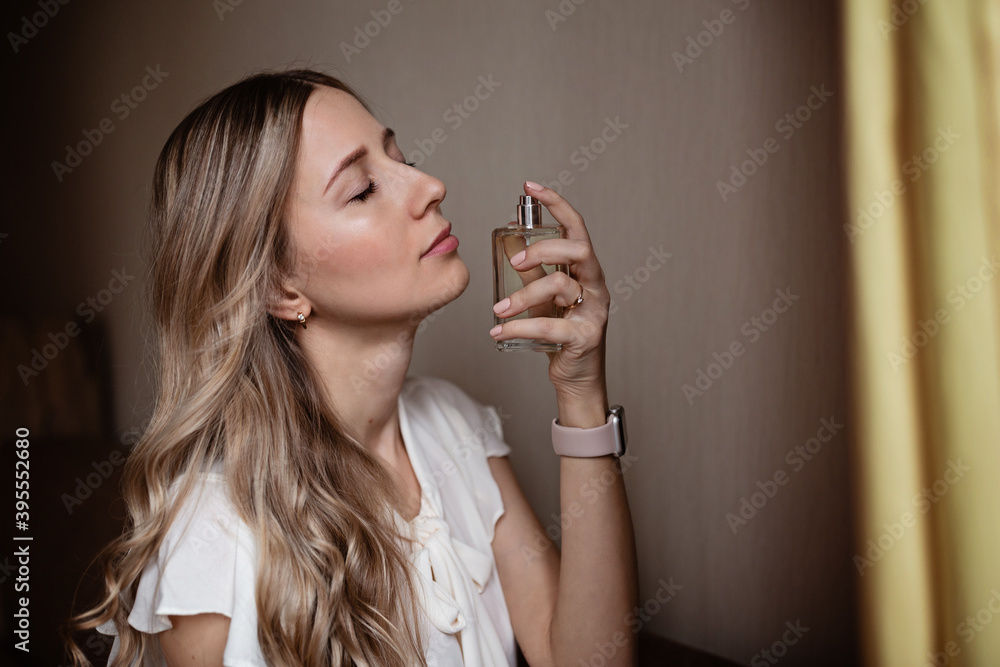 Beautiful young woman with bottle of perfume Beautiful young woman with bottle of perfume