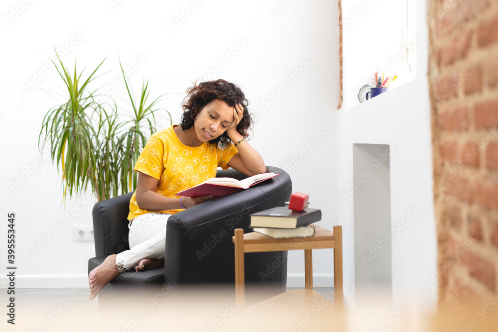 Portrait of a beautiful woman reading a book at home. Space for text. Portrait of a beautiful woman reading a book at home. Space for text.