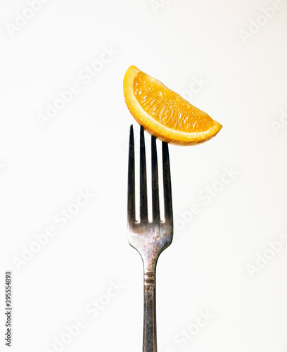 Orange slice on a fork photo