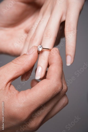 Man Placing Engagement Ring In Woman s Finger
