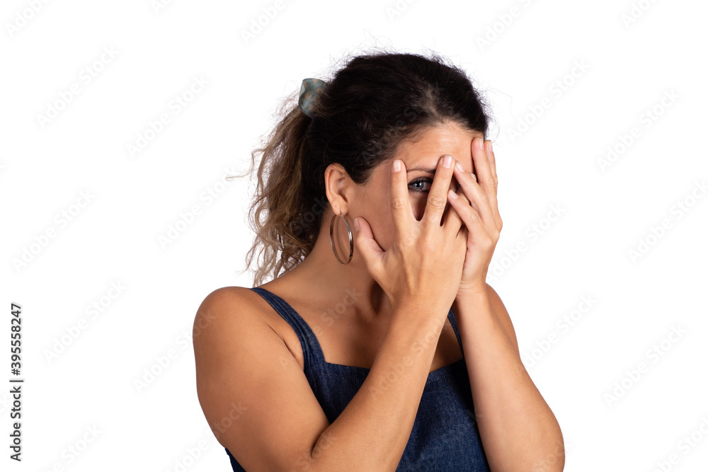 Young woman looking shy hiding behind her hand. Young woman looking shy hiding behind her hand.