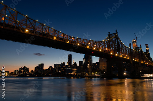 Fototapeta Naklejka Na Ścianę i Meble -  The Queensboro Bridge during the Evening with the Manhattan Skyline along the East River in New York City