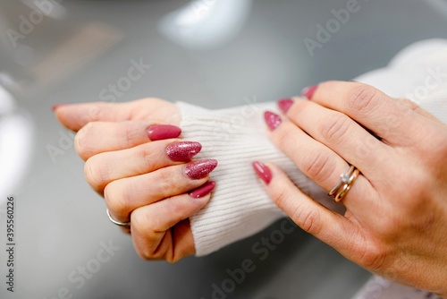 Close up woman hand showing fuchsia, violet polish. Nail art styling, beauty, manicure concept.