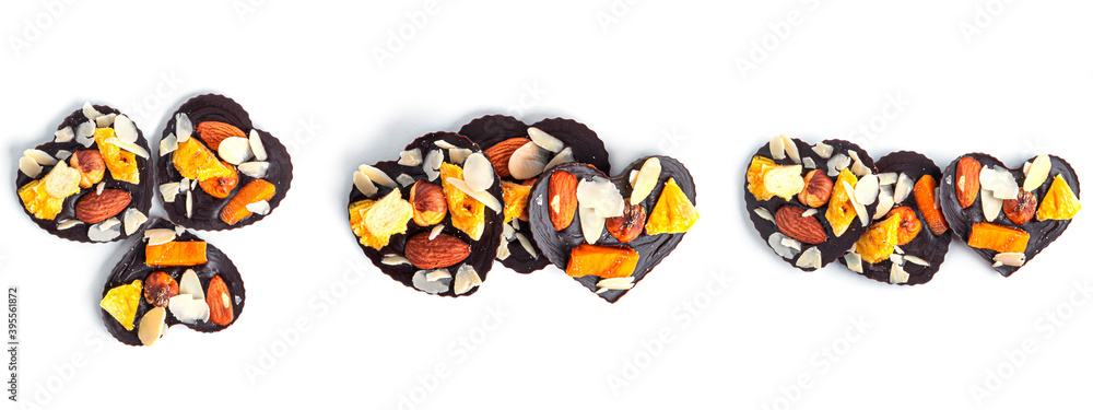 Raw heart shaped chocolate with dried fruits and nuts on a white background. High quality photo