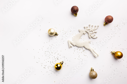 Christmas gold decorations and deer on white background  top view. Winter Decoration Background