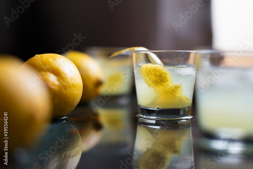 Limoncello with ice cubes and fresh lemon peel photo