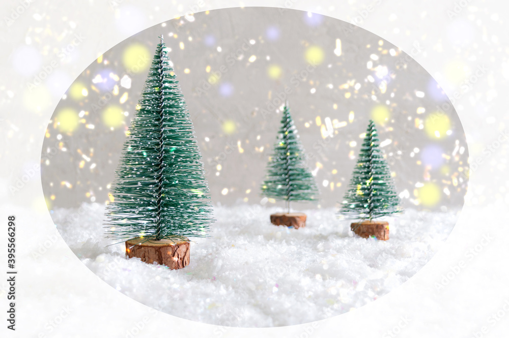 Christmas toy trees on simulated snow. Beautiful festive background for postcards, web, print. Christmas holiday celebration concept