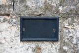 Street number blank metal sign on stone wall. House address