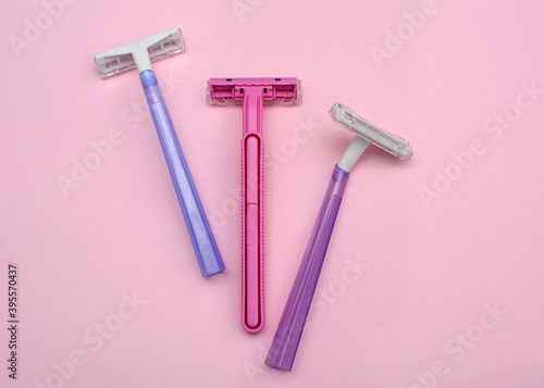 Layout of female disposable razors on a pink background. Close-up