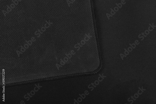 Texture of black fabric gaming mouse pad closeup photo