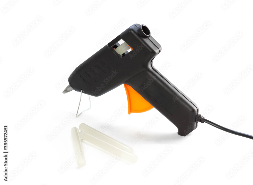 Glue gun with rods. Close up. Isolated on a white background Glue gun with rods. Close up. Isolated on a white background