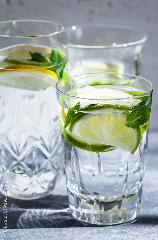 Various water glasses filled with lemons, limes, mint and ginger Various water glasses filled with lemons, limes, mint and ginger