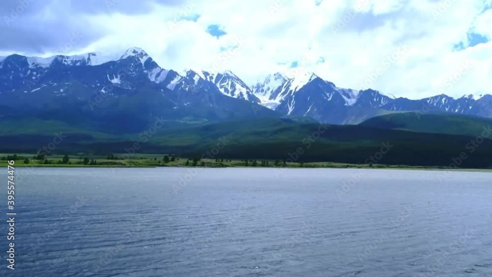 Beautiful white Mountains and big River in Switzerland in daytime and many clouds skyline Beautiful white Mountains and big River in Switzerland in daytime and many clouds skyline