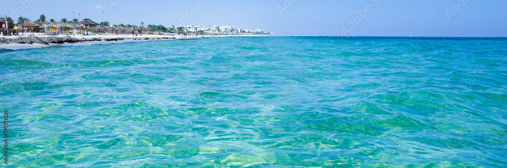 Calm sea, blue water, sky and horizon scene in Tunisia. Vacation relaxing concept. Web banner for your design.
