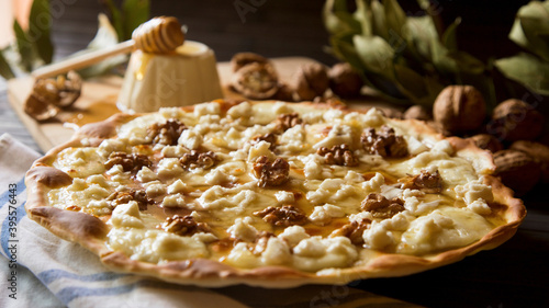 Sweet pizza with walnuts, goat cheese and honey
