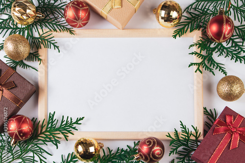 Gift boxes and gold festive decor on white background. Mock up for Christmas advertisement.