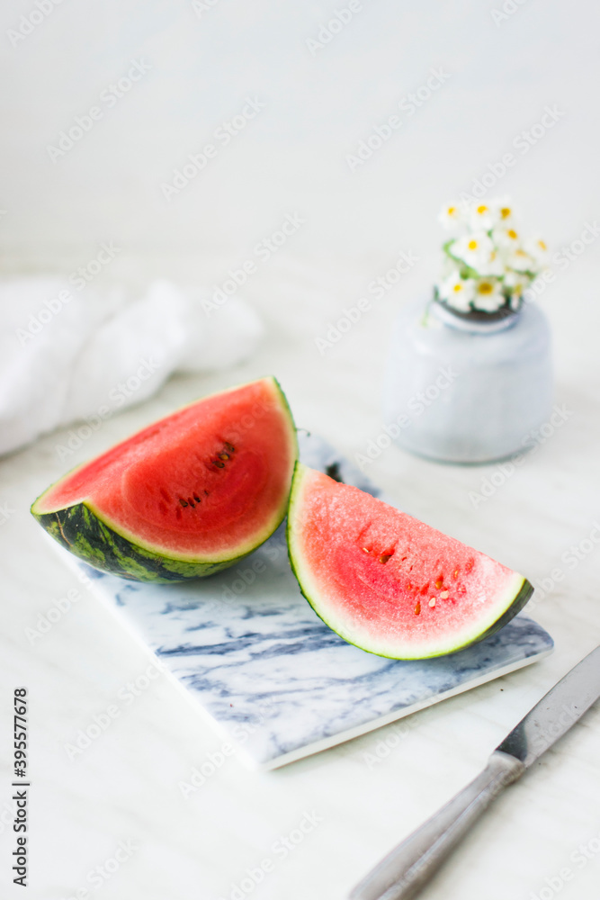 Watermelon wedges on a marble chopping board Watermelon wedges on a marble chopping board